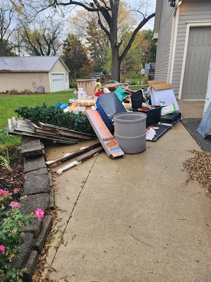 Dumpster being loaded with debris for Estate Cleanout Dumpster Rental in Bosque Farms